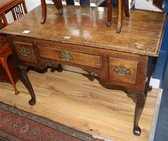 A mid 18th century oak lowboy, fitted three small drawers, on cabriole supports W.100cm